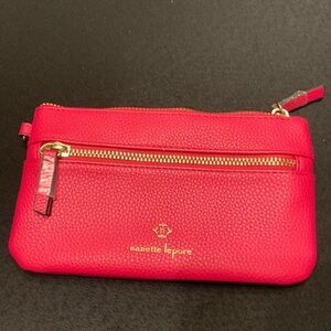 Nanette Lepore wristlet in Rosy pink color. Vegan pebbled leather.